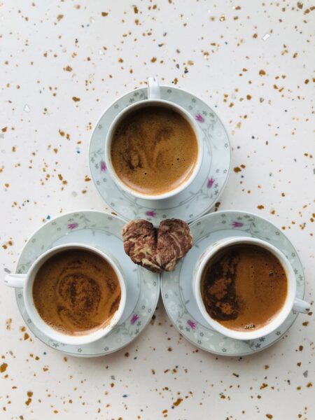 heart shape bread and cups of coffee