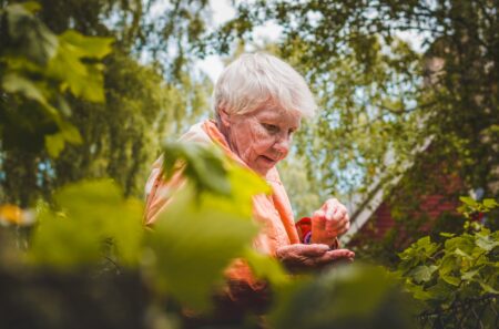 shallow focus photo of woman near plants